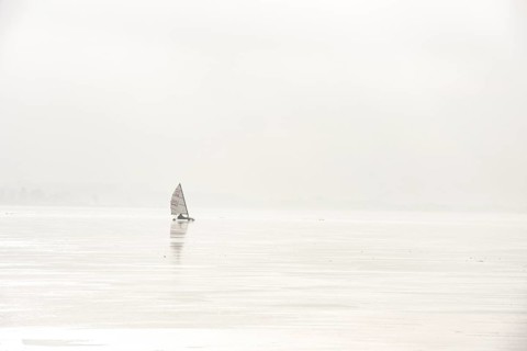 Ice sailor on the frozen alone on a foggy, frozen lake, minimalistic winter atmosphere, Dümmer See,