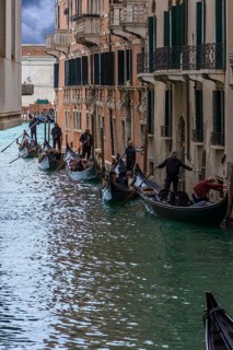 Many gondolas with tourists on tour through the canals of the old town, Venice, Veneto, Italy