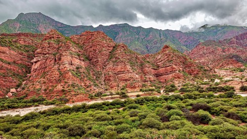 Wild, mountainous landscape with red rocks and thick clouds, The landscape and colorful rock