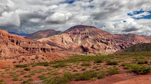 Wide mountain landscape with rock walls and clouds in the sky, the landscape and colorful rock