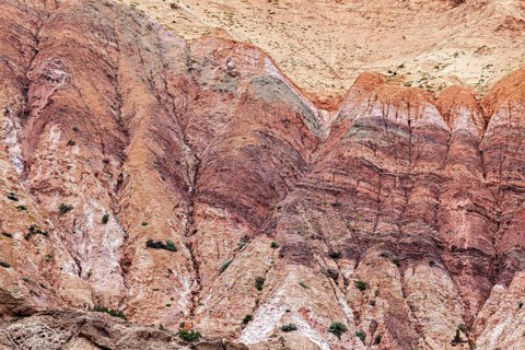 Colourful rocks with distinct rock layers that form an impressive geological formation, colorful