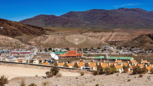 View of a small village in a hill and mountain landscape with central antenna, San Antonio de los