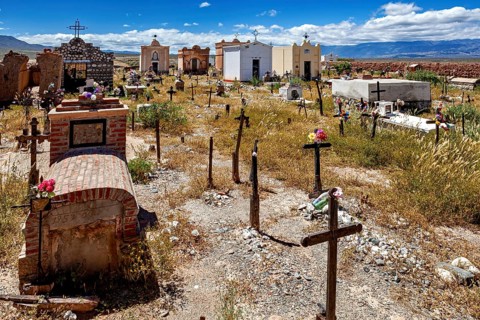 Old cemetery with graves and crosses under a blue sky with clouds, The cemetery of Cachi in