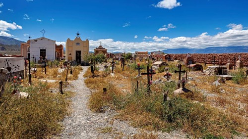 Path through an old cemetery with chapels and crosses in sunny weather, The cemetery of Cachi in