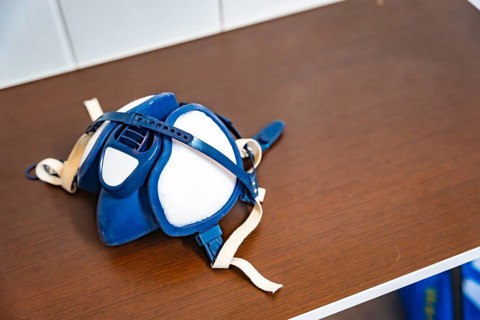 Respirator mask on a dusty workbench, highlighting essential ppe for automotive and industrial