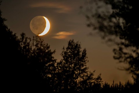 Part of the moon illuminated by the sun., Gaspésie national park, Province of Quebec, Canada