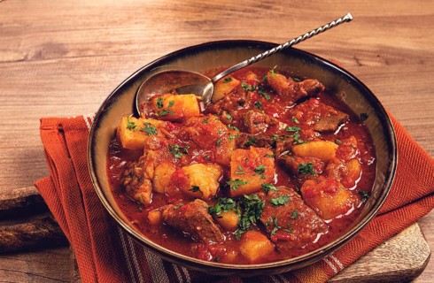 Potatoes with meat, stewed in tomato sauce, with spices and herbs, homemade, no people