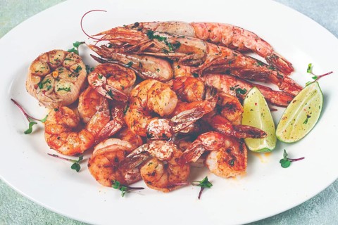 Fried langoustines and tiger shrimps, with spices and herbs, homemade dish, without people