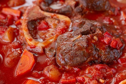 Ossobuco stew with vegetables, knuckle on the bone with new potatoes, in tomato sauce, homemade,