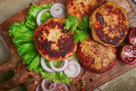 Fried chicken cutlets, minced chicken, with vegetables, on a cutting board, with vegetable salad,