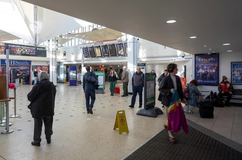 People in concourse of railway station at Plymouth, Devon, England, UK