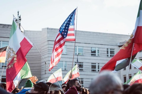 Flags of Iran and the USA during the demonstration by exiled Iranians under the slogan Freedom for