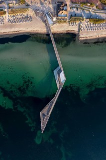 Aerial view over Seebrücke, pier and sandy beach at seaside resort Haffkrug along the Baltic Sea,