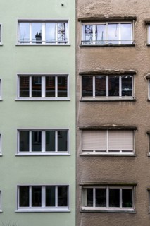 Windows, gray house facades, a house is renovated, renovation, modernization, contrast, difference,