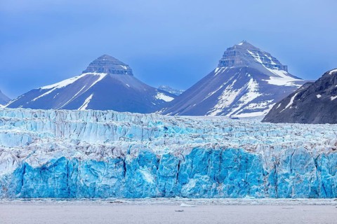 Calving ice wall of Kongsbreen, marine-terminating glacier debouching into Kongsfjorden in summer,