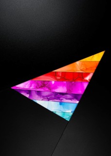 A bold triangular design featuring vibrant colors inks like orange, red, purple, and blue against a