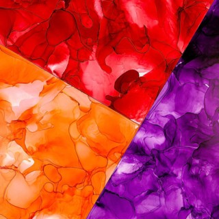 A dynamic blend of red, orange, and purple inks form an abstract color pattern on paper. The