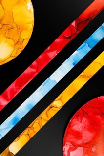 A vibrant abstract image featuring colorful geometric shapes on paper. Bold red, yellow, and blue