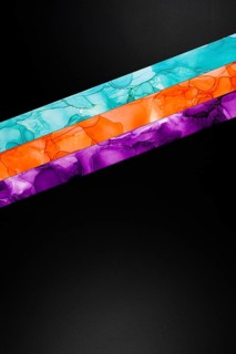Vibrant diagonal colors inks stripes of teal, orange, and purple on a dark background. This