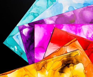 A collection of vibrant abstract ink backgrounds showcasing various vivid colors on paper. Perfect