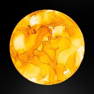 A striking circular design with swirls of orange and yellow on a dark backdrop of paper, creating a