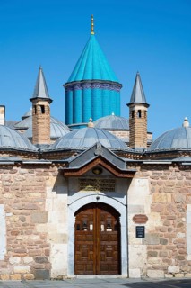 Turquoise dome on historic mausoleum nestled against a blue sky, Mevlana Museum, Mevlana, landmark,