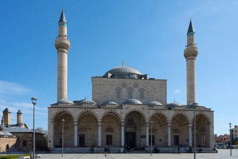 Historic mosque with two minarets and an impressive dome under clear skies, Selimiye Mosque, Konya