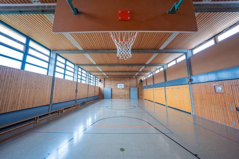 Large, bright gym with basketball hoop and floor markings, Schlehengäu Grund Schule Gechingen, Calw