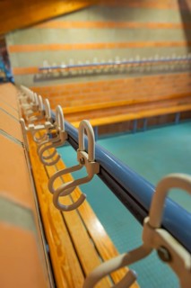 Close-up of a series of hooks in a changing room with blue tiles, Schlehengäu Grund Schule