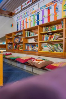 Educational area with well-stocked bookshelf and colorful seating, Schlehengäu Grund Schule