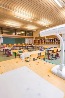 Classroom view from the teacher's desk with a view of blackboard and arranged rows of seats,