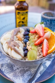 Healthy breakfast with fruit and cereal in a bowl on a table outside, Calw, Calw district, Germany