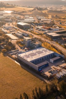 Aerial view of industrial landscape with buildings, fields and roads at sunset, Calw, Calw