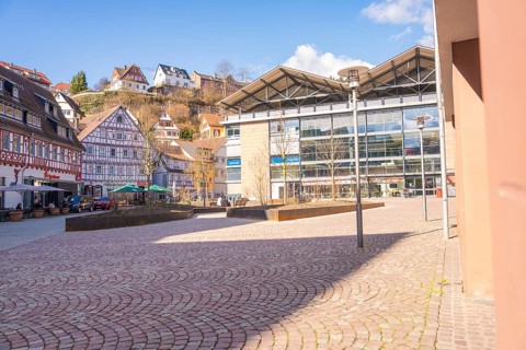 Town square with a mix of modern and traditional architecture in sunny weather, Calw, Calw