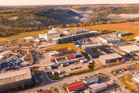 Industrial area surrounded by forest and hills with urban features, new hospital at Calw Health