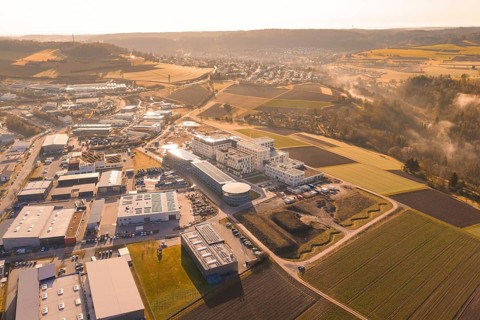 Extensive industrial area against a rural backdrop at golden hour, new hospital at Calw Health