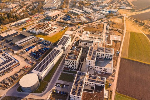 Aerial view of a modern industrial plant surrounded by city and nature, new hospital at the Calw
