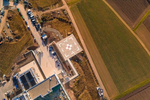 Aerial view of the helicopter landing pad in a rural region with infrastructure, new hospital at