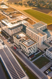 Modern architecture using solar energy in an urban facility surrounded by fields, new hospital at