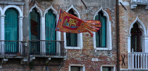 Waving flag of the Republic of Venice on a palace, Venice, Veneto, Italy