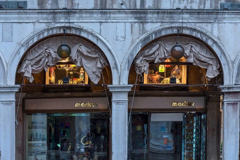Shops under the arcades of authorized offices in the morning, Venice, Veneto, Italy