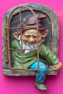 Garden gnome on a house wall, Burano, Veneto, Italy