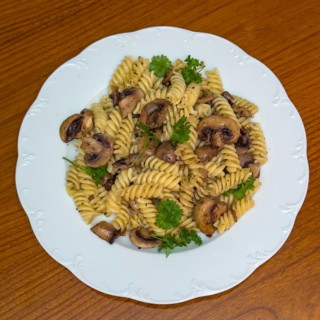 Vegan Italian dish pasta whole grain pasta with mushrooms mushrooms garnished with parsley,