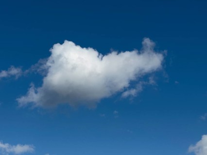 Single white cloud Cumulus fractus torn ragged cluster cloud without sharp lower limit on blue sky,