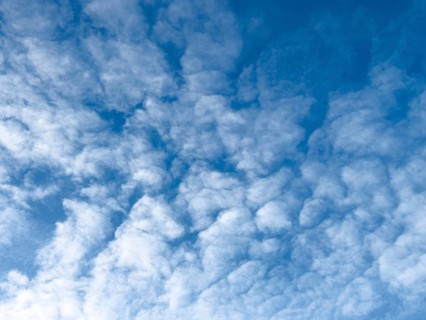 Medium-height white clouds of Altocumulus in blue sky, international