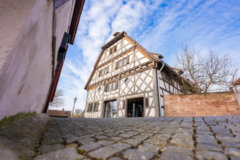 Timbered house on cobblestone road, traditional style under blue sky, Ötisheim, Enzkreis, Germany