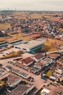 Residential area in a city surrounded by fields and trees seen from the air, Ötisheim, Enzkreis,