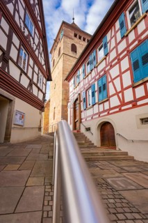 Historic half-timbered houses with church tower and stairs, sunny weather, Ötisheim, Enzkreis,