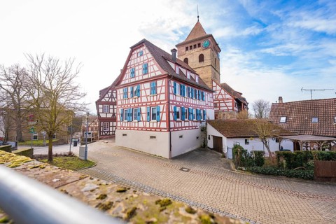 Village view with half-timbered houses and church tower under blue sky, Ötisheim, Enzkreis, Germany