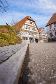 Street scene with traditional half-timbered house and tiled roof under sky, Ötisheim, Enzkreis,